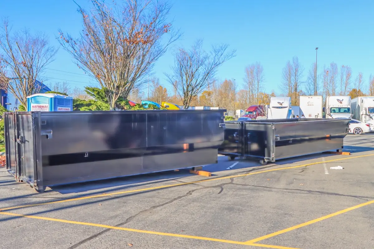 Professional dumpster rental service with roll-off container on residential driveway in Hiram